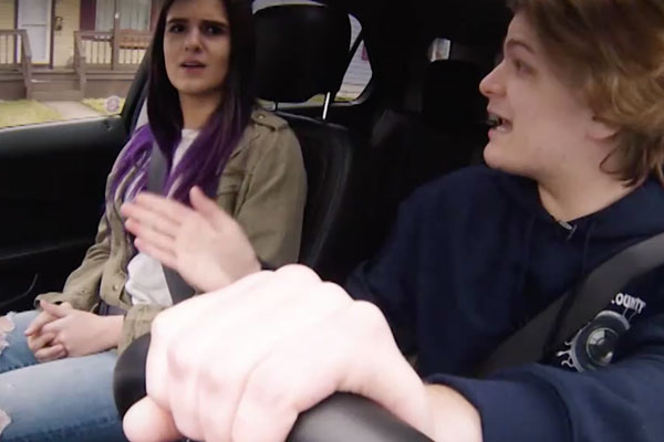 two teens in a car arguing