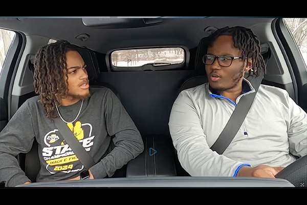 two teens in a car looking at each other