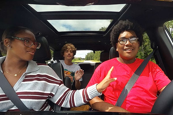 3 teens in a car