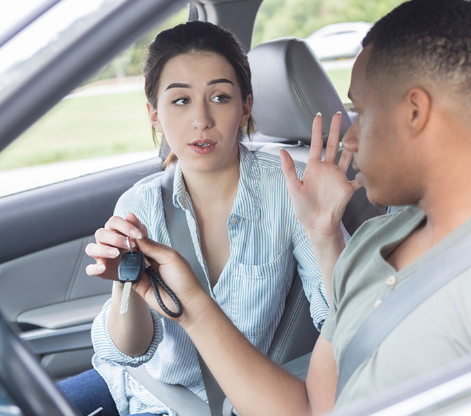 passenger taking keys from the driver