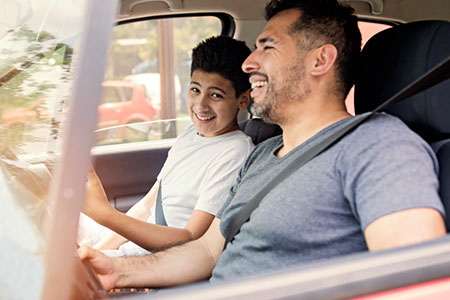 Dad driving his teenage child