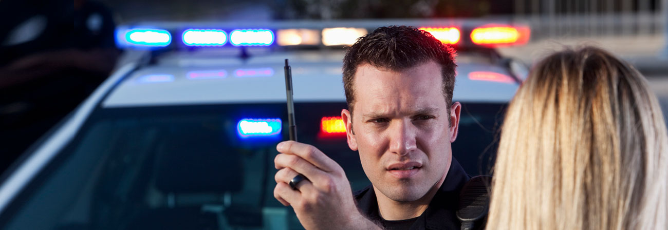 police officer conducting a sobriety test to a woman