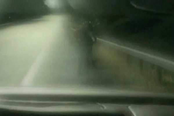 blurry car windshield with a child on a bike