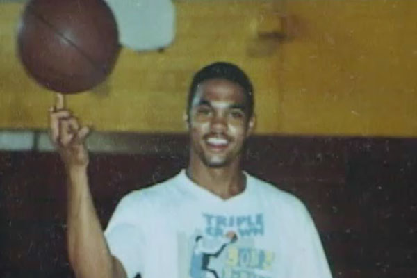 a teen boy twirling a basketball