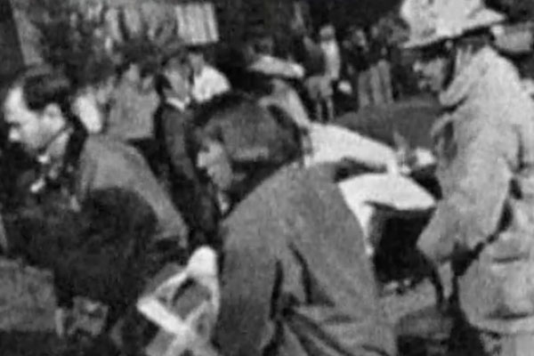 black and white photo of people responding to an accident