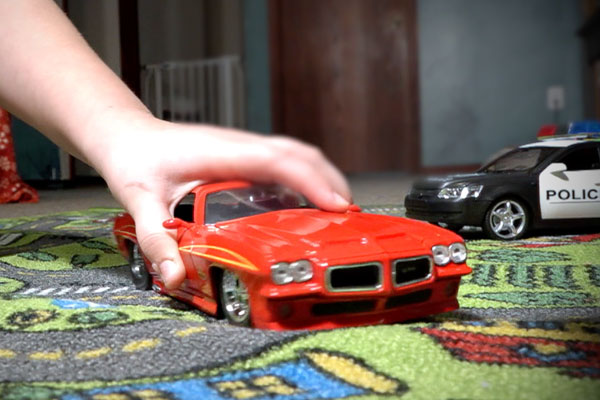 child playing with toy car