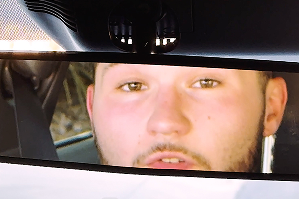 driver looking into a rear view mirror